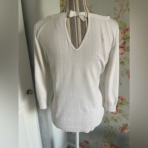 Super cute off white sweater with perfect v cut detail in the back.